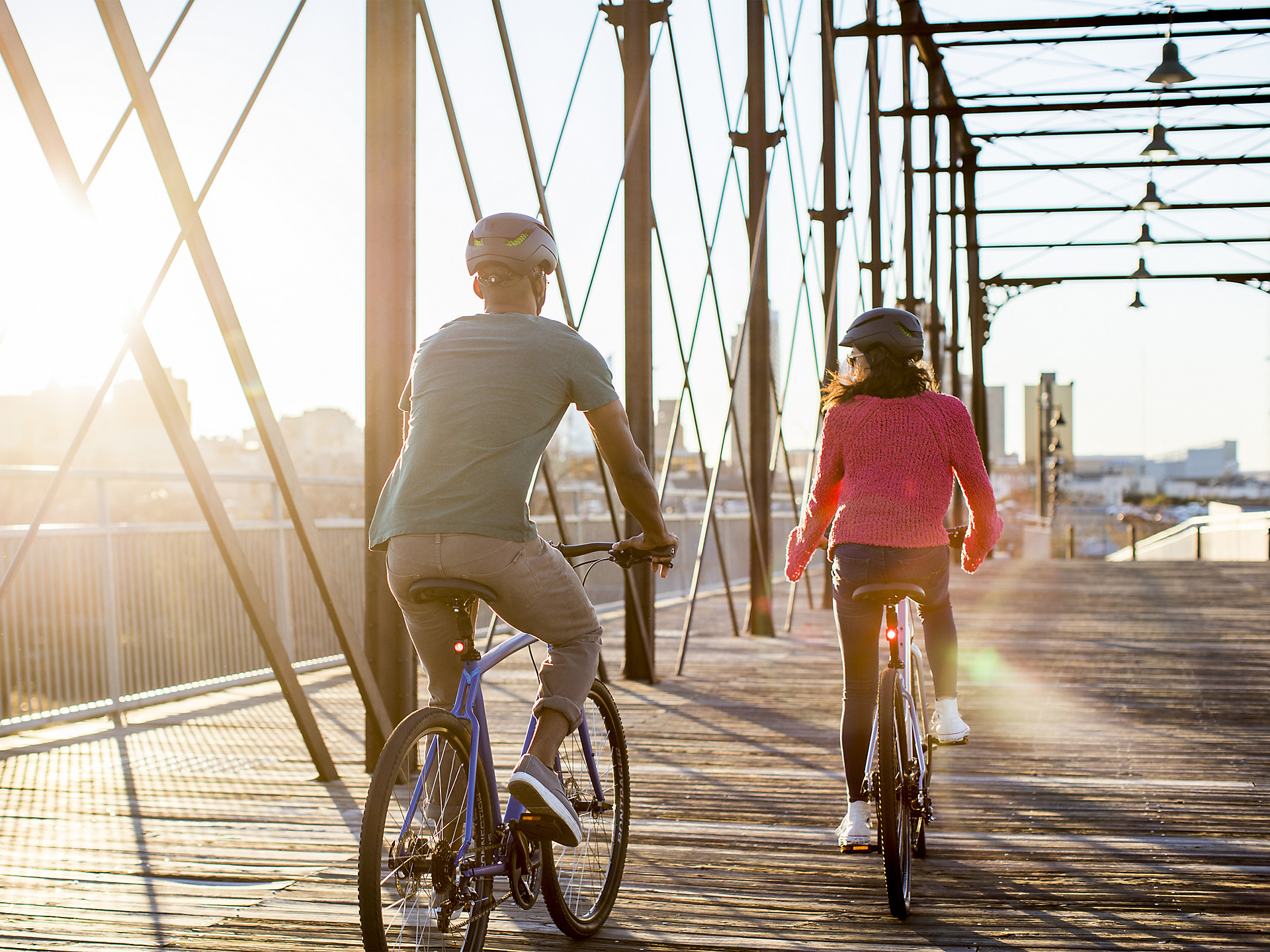 man and women riding on trek verve hybrid bikes on a bridge